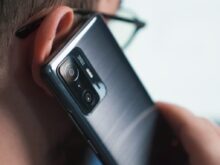a close up of a person talking on a cell phone