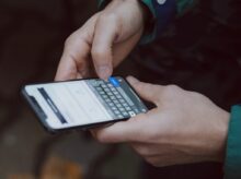 selective focus photography of person using smartphone