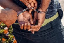 Person in Black Denim Jeans Holding Silver Bracelet