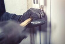 Person Opening a Door with a Bar
