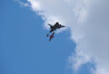 modern and classic planes flying side by side in aerial show