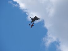modern and classic planes flying side by side in aerial show