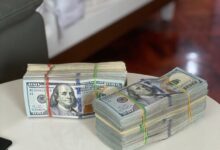 a stack of money sitting on top of a white table