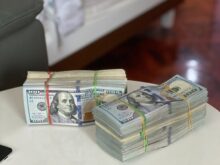a stack of money sitting on top of a white table