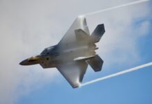 black jet plane in mid air during daytime