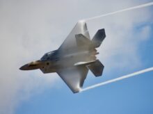 black jet plane in mid air during daytime