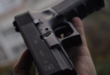 person holding black semi automatic pistol