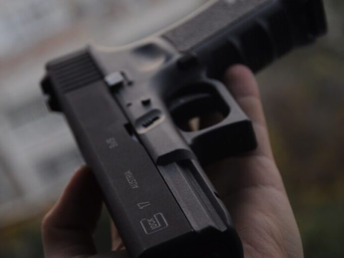 person holding black semi automatic pistol