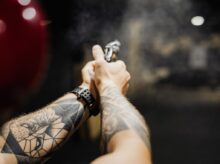 Hands of a Person Holding a Firearm