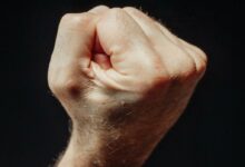 Close-Up Photo of a Person Clenching His Fist
