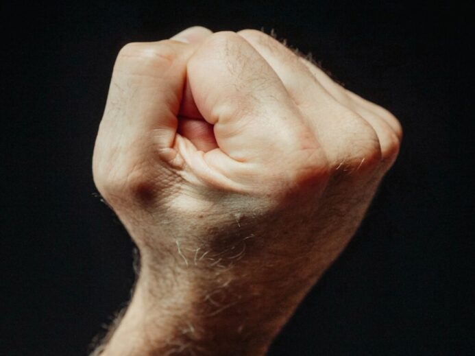 Close-Up Photo of a Person Clenching His Fist