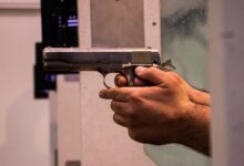 person holding black and silver semi automatic pistol