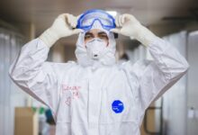person in white and blue mask and white long sleeve shirt