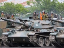 people riding battle tank during daytime