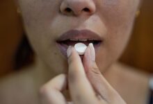 woman putting her hand on her lips