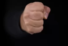 persons fist on black background