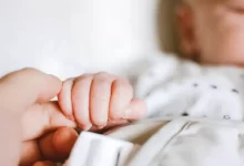 Person Holding Baby's Hand