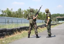 Two Soldiers Standing On Road