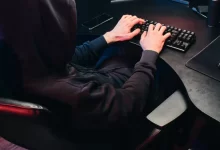 Back View of a Person Typing on a Keyboard