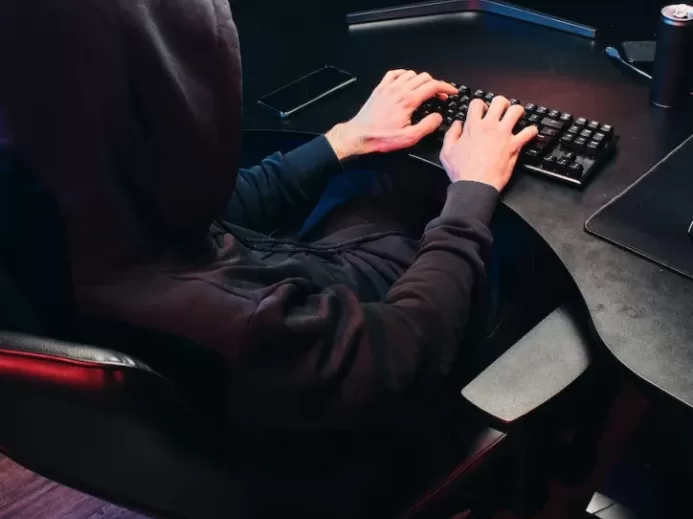 Back View of a Person Typing on a Keyboard