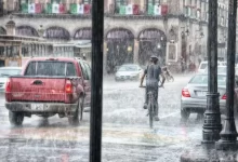 Person Riding a Bicycle during Rainy Day
