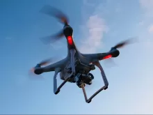drone flying under white sky