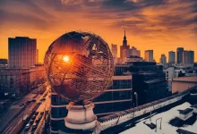 white round globe statue near city buildings during night time