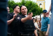 man in black police uniform standing near people during daytime