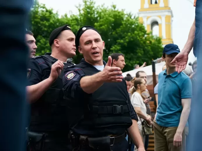 man in black police uniform standing near people during daytime