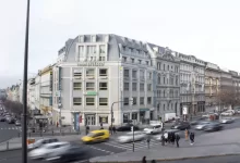 cars parked in front of white building during daytime