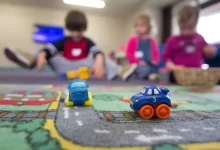 a group of children playing with toys on the floor