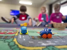 a group of children playing with toys on the floor