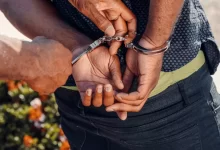 Person in Black Denim Jeans Holding Silver Bracelet
