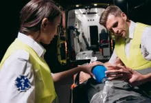 Paramedics Giving First Aid to a Person Lying on a Stretcher