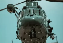 a close up of a helicopter flying in the sky