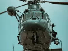 a close up of a helicopter flying in the sky