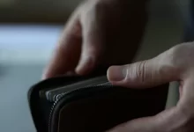 a person holding a wallet in their hand
