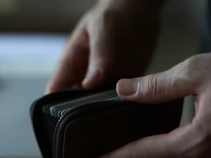 a person holding a wallet in their hand