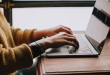 person sitting front of laptop