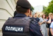 man in black police uniform standing in front of people during daytime