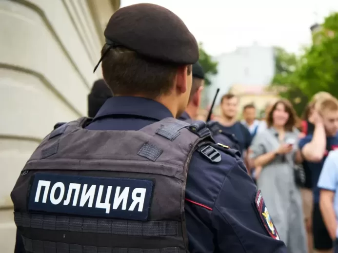 man in black police uniform standing in front of people during daytime