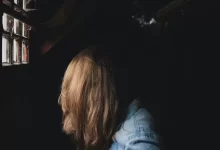 person sitting beside window