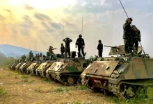 soldiers on top of battle tanks