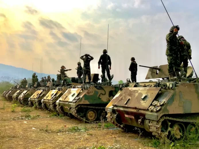 soldiers on top of battle tanks