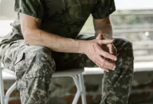 Man in Green and Brown Camouflage Shirt