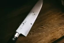 gray knife on brown wooden surface