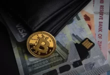 a bitcoin sitting on top of a pile of money