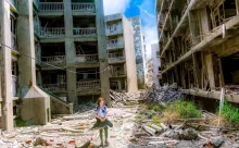 woman wearing white and green dress surrounded by storey buildings