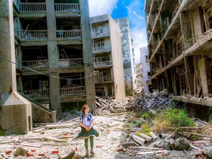 woman wearing white and green dress surrounded by storey buildings
