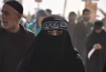 group of people in black walking